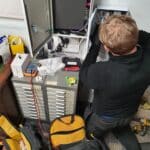 man working on wiring by Mech-Elec Group Ltd