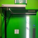 Automated door system by fire exit by Mech-Elec Group Ltd